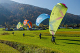 Four people with paramotor wings