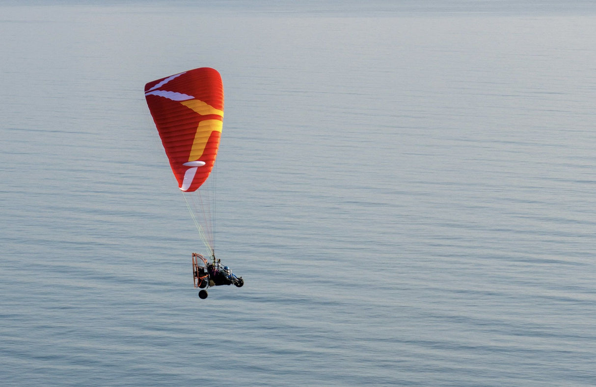 triox2 paratrike flying over the sea