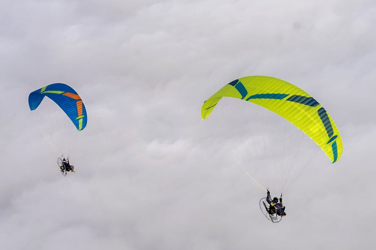 two people flying paramotors in clouds with Viper 61 wings