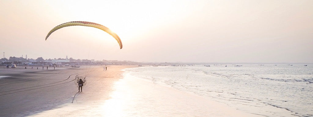 man on beach next to shore