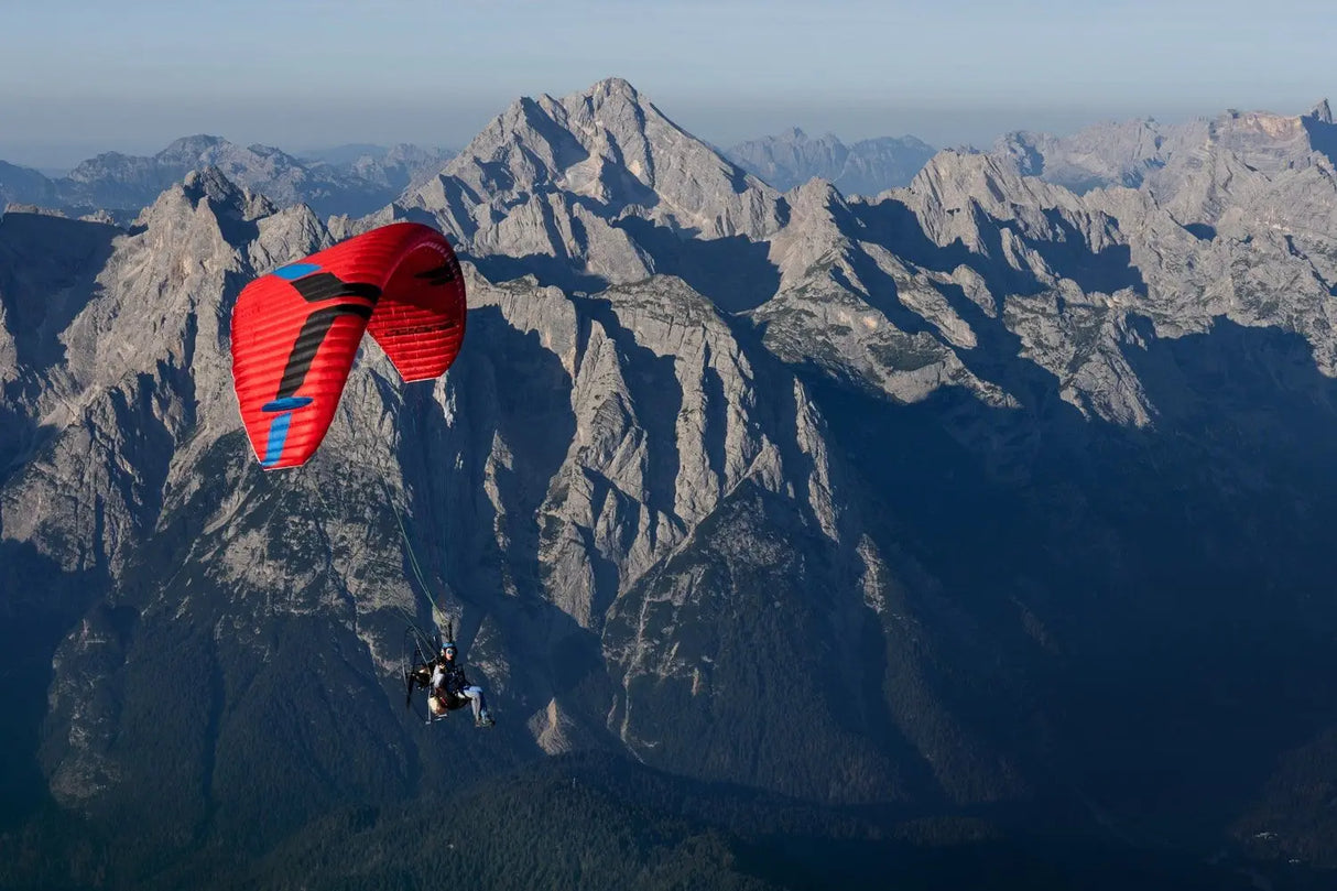 person paragliding in from of a mountain