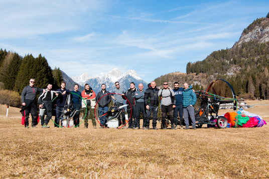 Group of people with outdoor equipment in a mountainous landscape