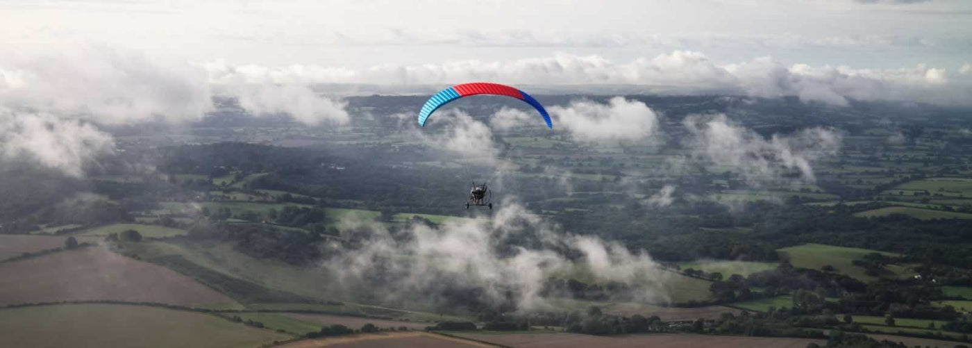 paratrike flying amongst the sky in the UK
