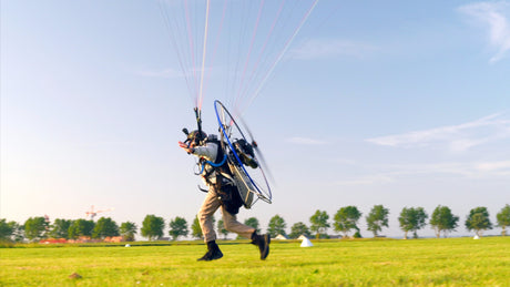 man running with paramotor