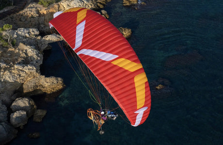 paratrike flying with wing over sea