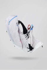 White backpack with black straps on a light gray background