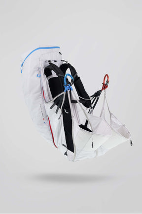 White backpack with black straps and red accents on a light gray background