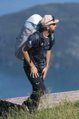 Man hiking with a backpack on a mountain trail