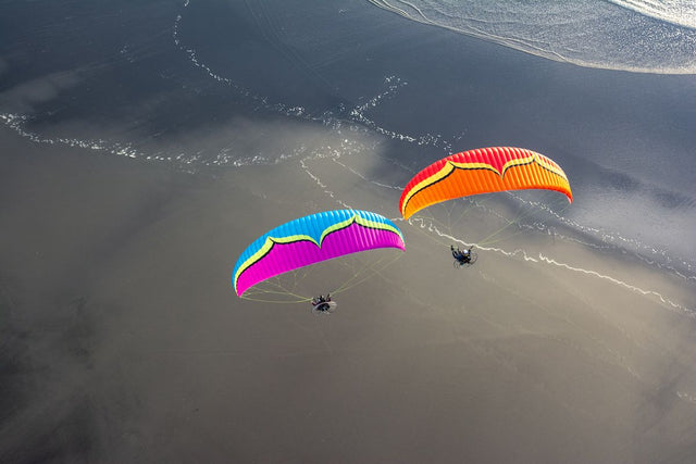 two people flying The Roadster 3 over the beach