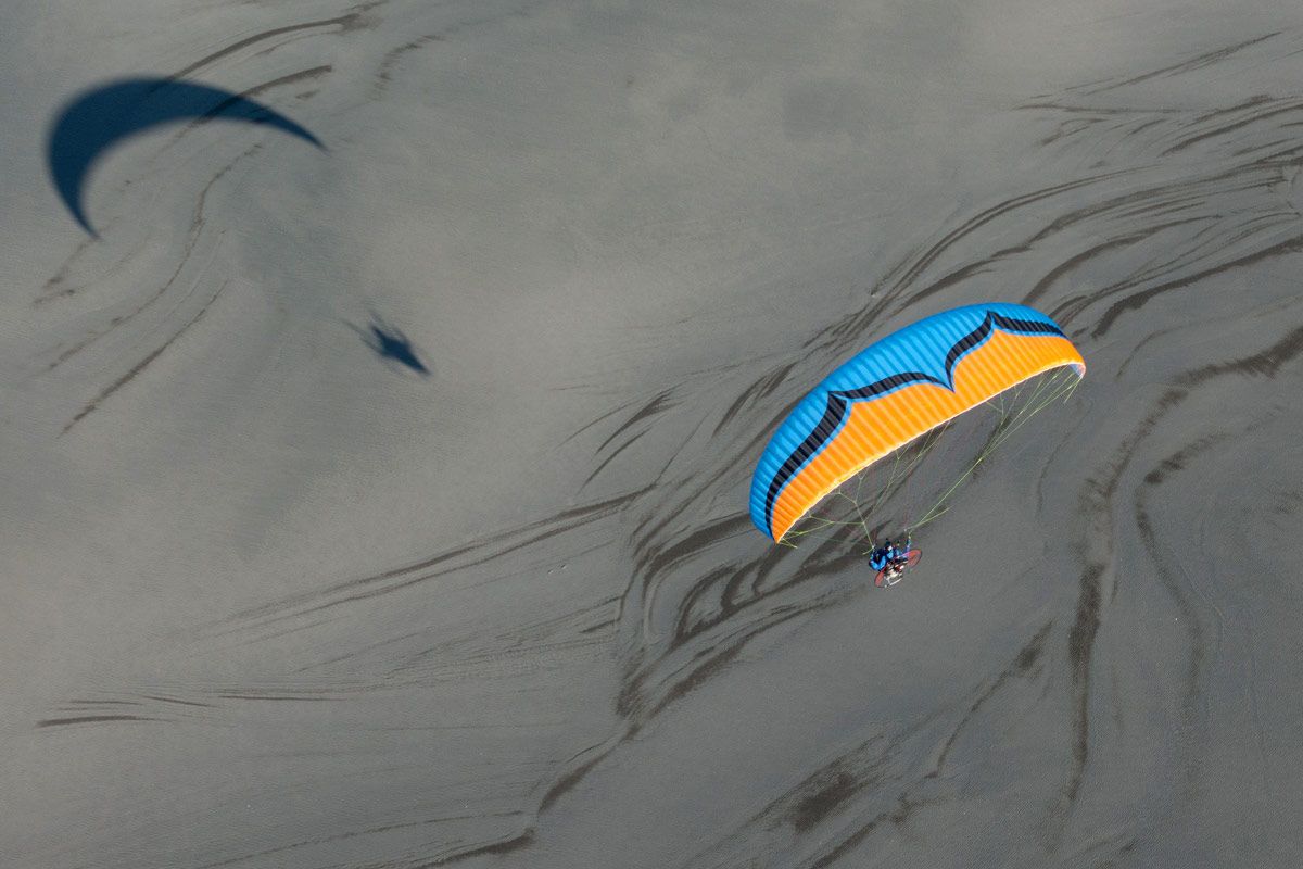 paramotor and wing flying above the ground