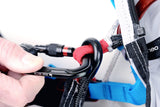 Close-up of a person adjusting a carabiner on a climbing harness.