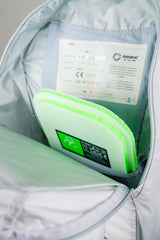 Green filter pocket with certification labels inside a backpack