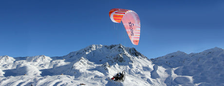 Two people flying using one Parajet